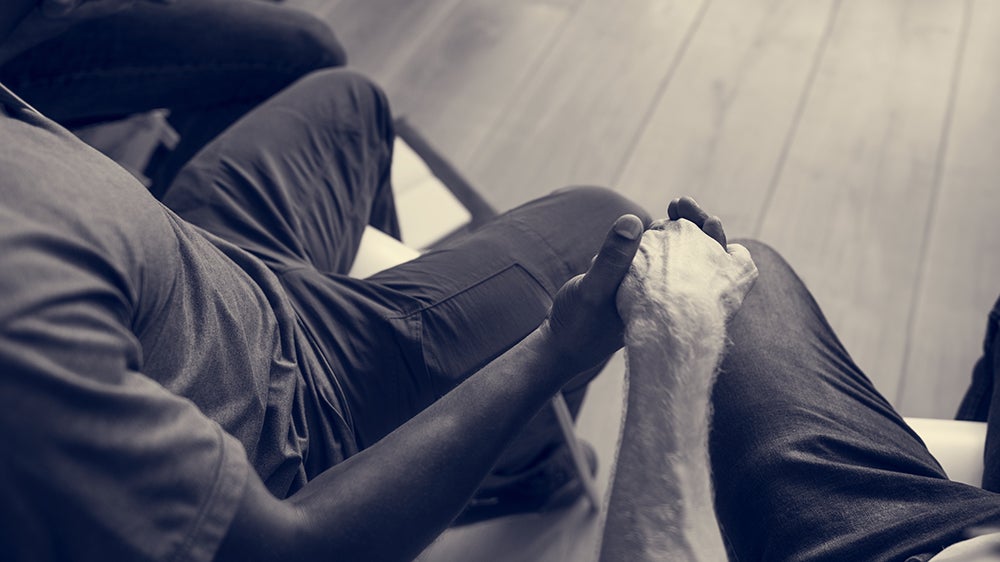 two people holding hands close up