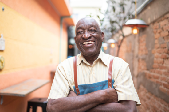 Senior male smiling at work