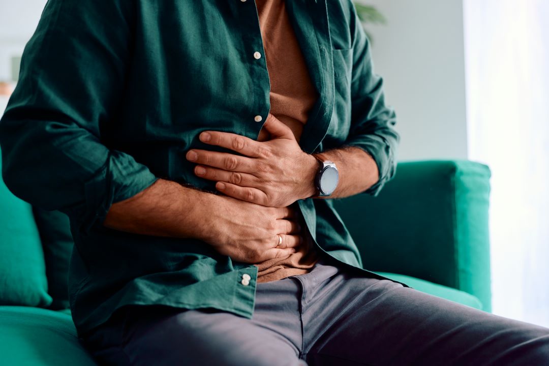 Man experiencing severe abdominal pain and stomach ache