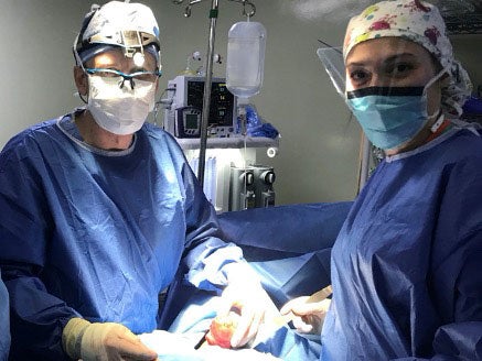 Leslie Addengast, MD with Ben Jarman, MD performing a thyroidectomy