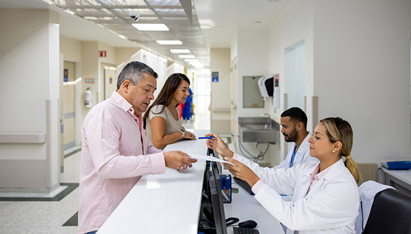man at front desk of hospital
